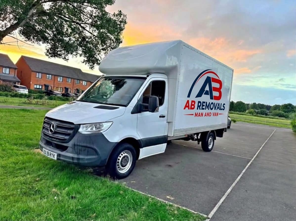 White 3.5-tonne Luton box van with AB Removals corporate logo livery decaled on the side and hydraulic tail lift